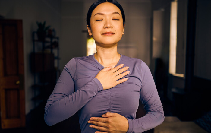 Breathing correctly makes everything better. Pilates breathing, woman breathing with hands on torso.