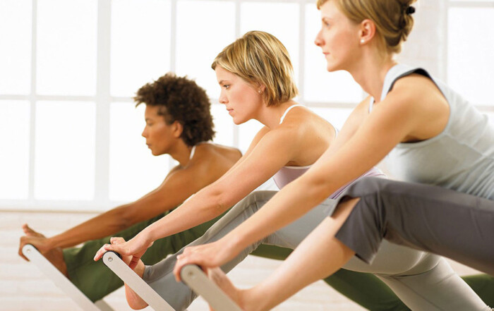 Pilates group of three individuals with equipment, in training, Instructor Training Courses and CECs