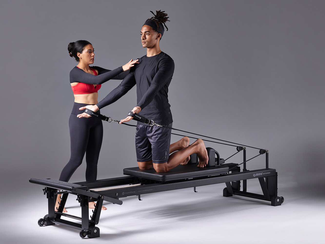Getting Started With Pilates, instructor guides student on reformer equipment